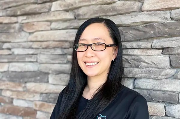 Angelina, dental hygienist, smiling at the dental office