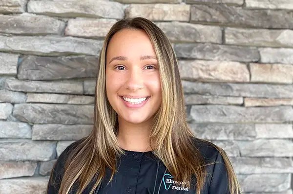 Nicole, dental hygienist, smiling at the dental office