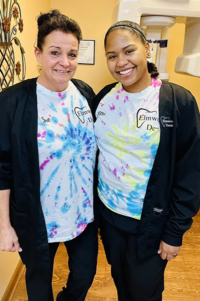 Colleagues in tie-dye shirts posing together for fun photo