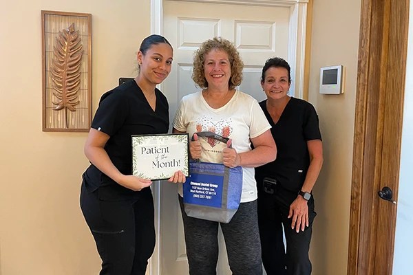 Group posing with &ldquo;Polk&rsquo;s Smile&rdquo; certificate at charity event