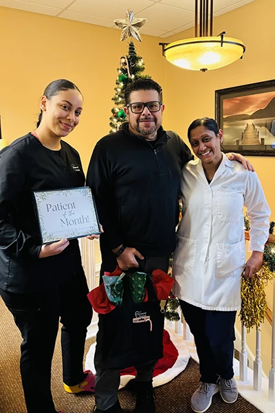 Group celebrating with holiday decorations and gifts