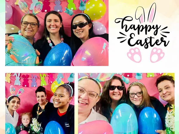 Staff celebrating Easter with balloons and &ldquo;Happy Easter&rdquo; sign