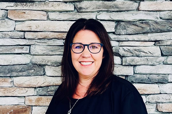 Melissa, practice administrator, smiling at the dental office